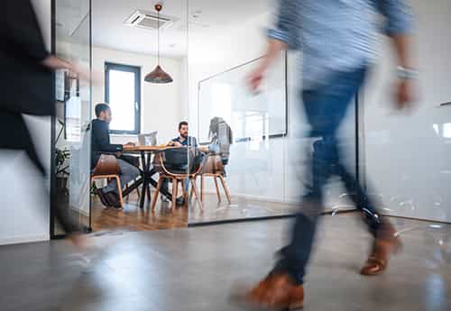 photo of coworkers discussing commercial real estate at a conference table in an office space